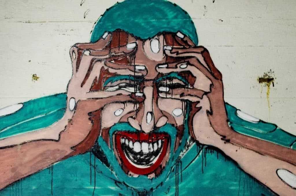 drawing of a man holding his face and looking like he's in pain